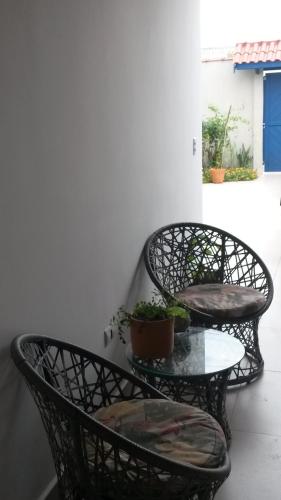 two chairs and a table on a balcony at Casa Centro De Ubatuba in Ubatuba