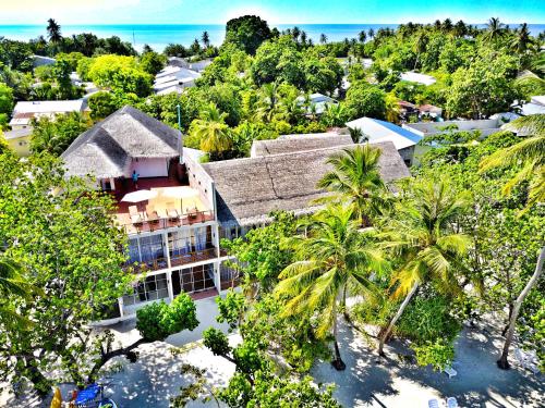 an aerial view of a resort with palm trees at Athiri Beach Maldives in Dhigurah