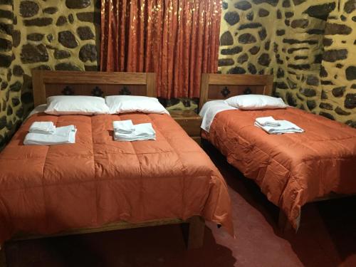 Postel nebo postele na pokoji v ubytování Rumi Sonqo Hostel