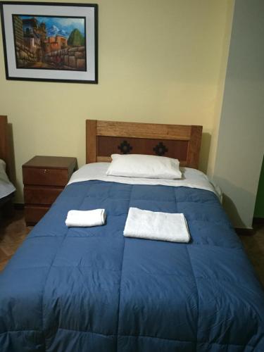Postel nebo postele na pokoji v ubytování Rumi Sonqo Hostel