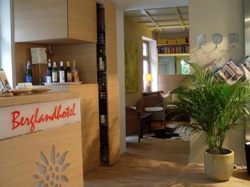 a room with a counter with bottles of wine at Bergland Hotel - Adults only in Salzburg