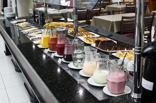 a buffet line with many different types of drinks at Miotto Executive Hotel in Navegantes