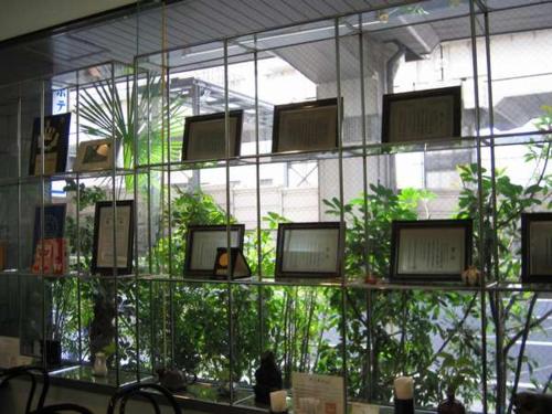 a room with a bunch of windows with plants at Nishishinjuku Green Hotel in Tokyo