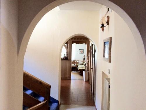 a hallway with an archway in a house at Garnì Serena in Canazei