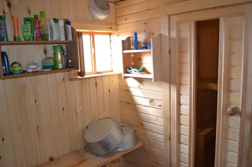フジュルにあるRybatskiy Beregの窓と鍋のある小さな木造の部屋
