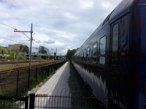 a train parked on the tracks next to a platform at Train Lodge Amsterdam in Amsterdam