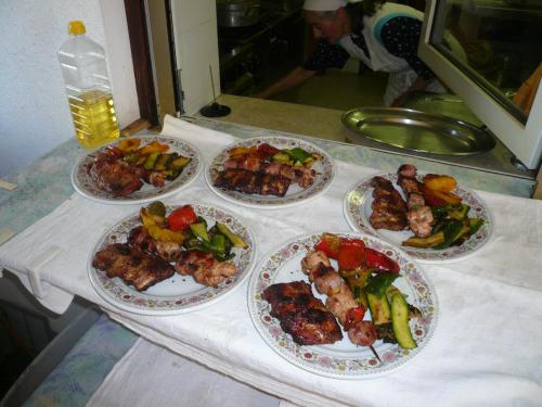 a table with four plates of food on it at Gasthof Specker in Obereggen