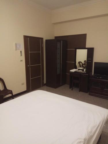 1 dormitorio con cama, tocador y espejo en Nature House, en Wanli