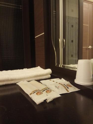 a bathroom with towels on a table with a mirror at Nature House in Wanli