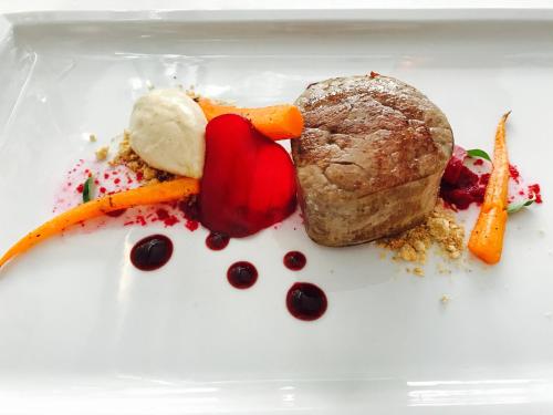 a plate of food with meat and vegetables on it at Locanda al Vescovo & SPA in Verona