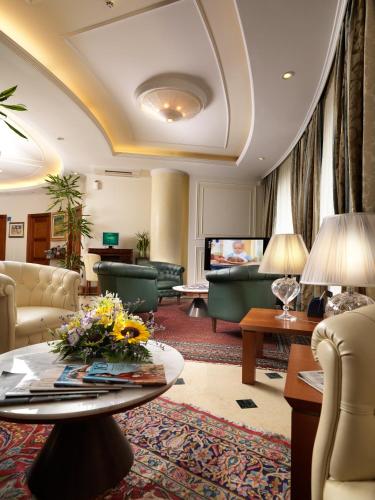 a living room with a couch and a table at Hotel Ariston in Campodarsego