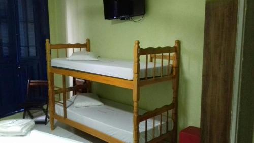 two bunk beds in a room with a tv at Hotel Michel in São Paulo