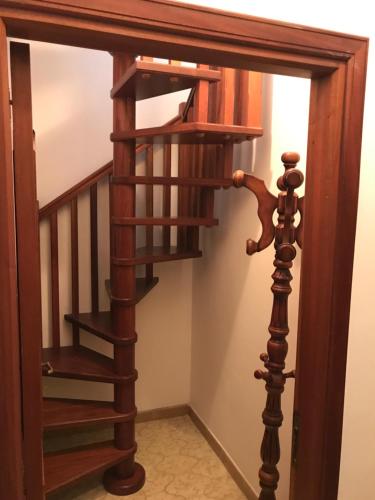 a spiral staircase in a home with a wooden stair case at Porto di Ponza - Immobilevante in Ponza