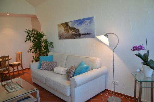 a living room with a couch with pillows on it at Hofgut Wollin GmbH in Putgarten