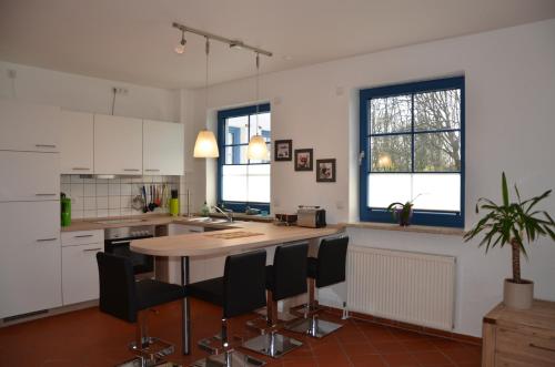 a kitchen with a table and chairs in it at Hofgut Wollin GmbH in Putgarten