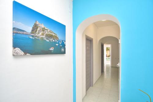 a hallway of a house with a painting on the wall at Charme Hotel La Villa Tina in Ischia