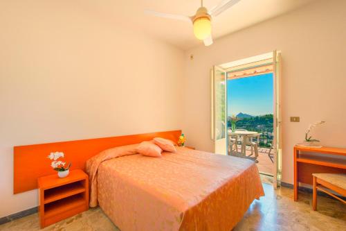 a bedroom with a bed and a door to a patio at Villa Angela Apartment in Ischia Town
