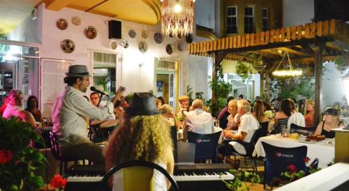 a group of people sitting at tables in a restaurant at Hotel Arco del Sol in Colmenar