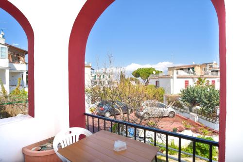 a balcony with a table and a view of a city at Charme Hotel La Villa Tina in Ischia