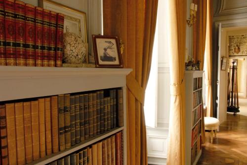 a book shelf with a bunch of books on it at Château de Boucéel - Mont Saint Michel in Vergoncey