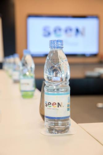 a bottle of water sitting on top of a table at Seen Hotel Abidjan Plateau in Abidjan