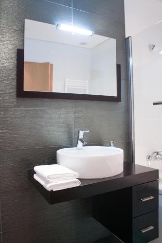 a bathroom with a sink and a mirror at Alto das Marinhas in Aveiro