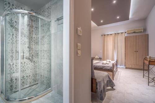 a bathroom with a shower and a bedroom at Armonia Boutique Hotel in Meson Yerakarion