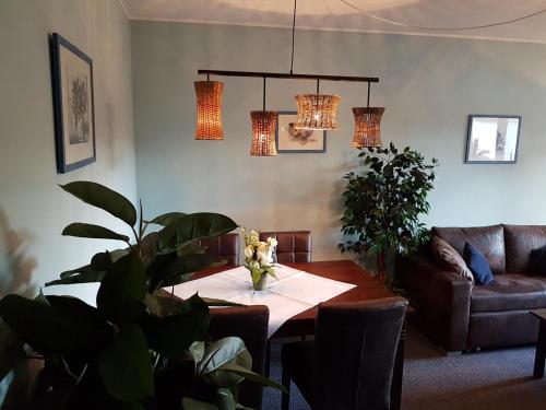 a living room with a table and a couch at Landhotel Grimmeblick in Winterberg