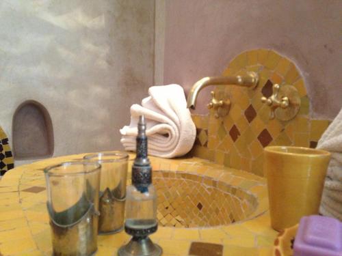a bathroom counter with a sink and a towel at Riad Mehdia in Marrakech