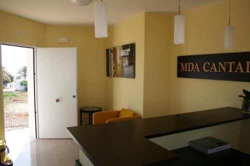 a waiting room with a black counter and a door at Mda Playa del Cantal in Mojácar