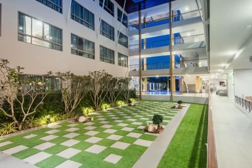 an internal courtyard of a building with a checkered floor at The Peak in Chanthaburi