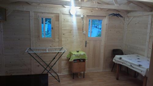 a room with wooden walls and a table and windows at Prague Retro Challenge and Garden in Prague
