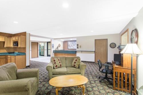 a living room with a couch and a table at Super 8 by Wyndham Dodgeville in Dodgeville