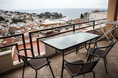 a table and chairs on a balcony with a view of the ocean at Apartments Aga in Ulcinj