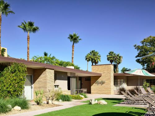 a house with palm trees in front of it at The Hideaway in Palm Springs