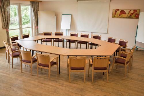 a conference room with a large table and chairs at Weststeirischer Hof in Bad Gams