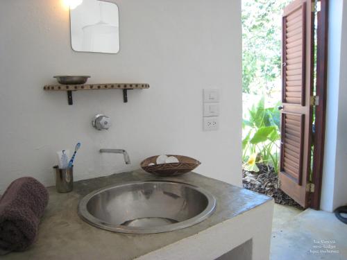a bathroom with a sink in a room at La Cueva Eco-Lodge in Las Galeras