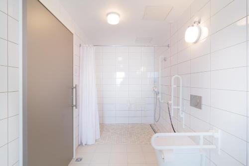 a bathroom with a sink, toilet and bathtub at Toyoko Inn Frankfurt am Main Hauptbahnhof in Frankfurt