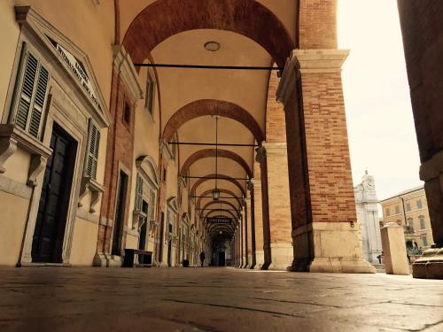 an empty street with an arcade in a building at Hotel Pellegrino E Pace in Loreto