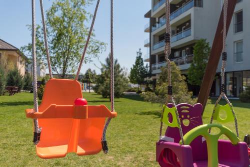 an empty swing set in a park at Bucharest Airport Suites & Villas in Otopeni