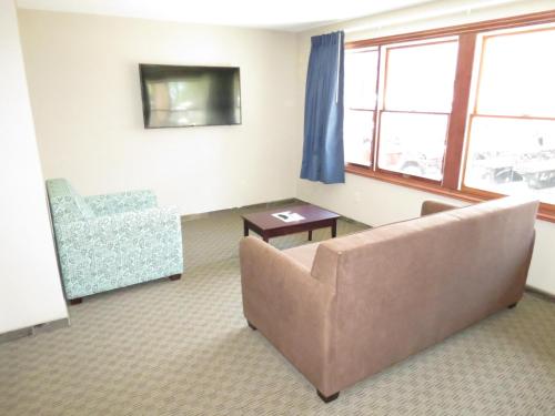 a living room with a couch and a chair at Edgewater Hotel and Suites in Put-in-Bay
