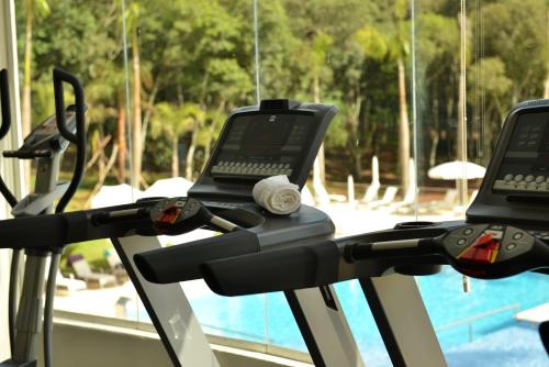 a treadmill with a laptop on it next to a pool at Falls Iguazú Hotel & Spa in Puerto Iguazú