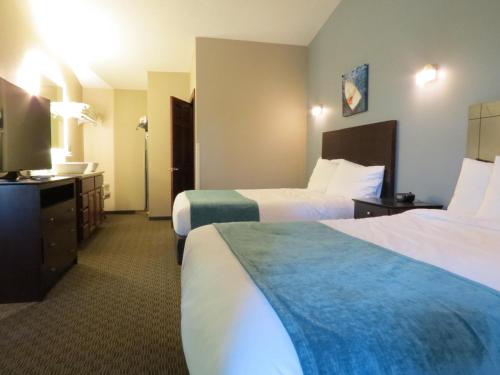 a hotel room with two beds and a television at Edgewater Hotel and Suites in Put-in-Bay