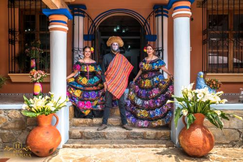 a group of three women and a man standing on a porch at Hotel Tierra Maya in San Cristóbal de Las Casas