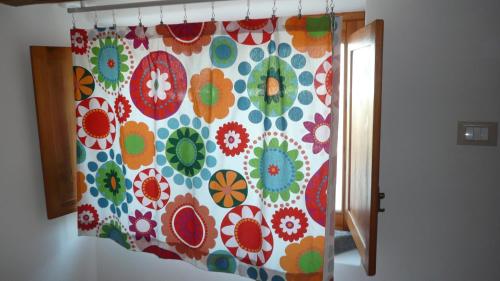 a shower curtain with a colorful flower pattern on it at La Casa del Pescatore in Filicudi