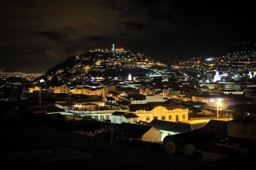 a view of a city at night at The Secret Garden in Quito