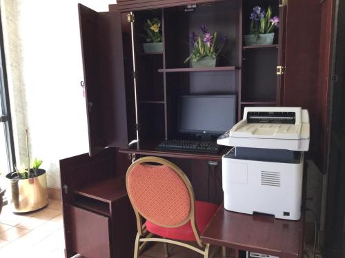 a desk with a computer and a laptop on it at Americas Best Value Inn and Suites Saint Charles in St. Charles