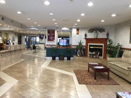 a lobby with a couch and a fireplace at Americas Best Value Inn and Suites Saint Charles in St. Charles