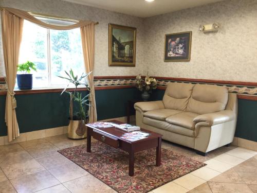 a living room with a couch and a coffee table at Americas Best Value Inn and Suites Saint Charles in St. Charles