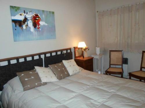 a bedroom with a large white bed with pillows at La Ignacia Bed and Breakfast in Pilar